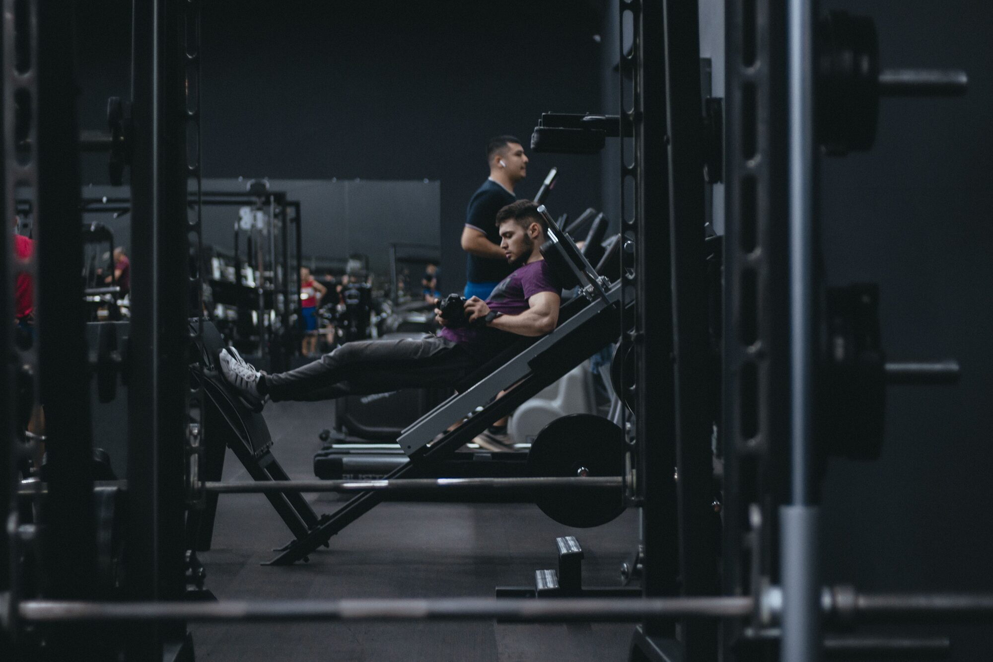 A person using a leg press machine in a gym